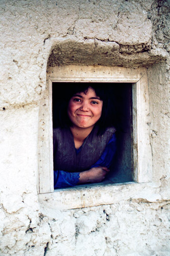 Afghan girl at window